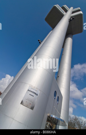 Vertical wide angle of David Cerny's Miminka 'Crawling Babies' on the Zizkov Television Tower against a bright blue sky. Stock Photo