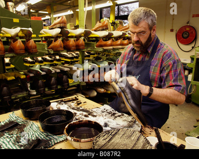 Older gentleman working in a shoe factory doing work manual labour skill craftsmanship van Bommel Stock Photo