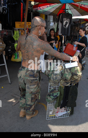 tattoo guy selling his stuff at chatuchak weekend market, bangkok,thailand. Stock Photo