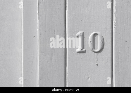 number ten 10 on white timber clad door Stock Photo