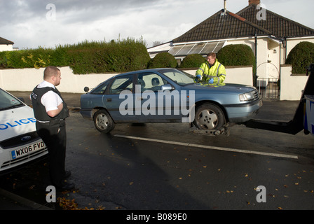 Vauxhall Cavalier being towed under guard by police after it was stolen in November 2007 Stock Photo