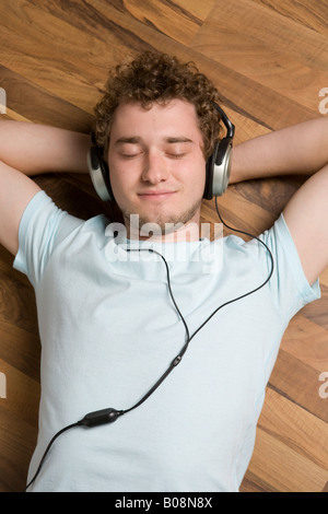 Young man listening to music with headphones Stock Photo
