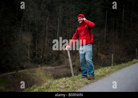 Young man talking on his mobile phone outdoors Stock Photo