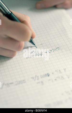 Schoolgirl doing home work, calculating, math equation Stock Photo