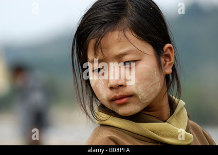 Girl with Tanaka paste on her face, Kachin State, Myanmar (Birma), Southeast Asia Stock Photo