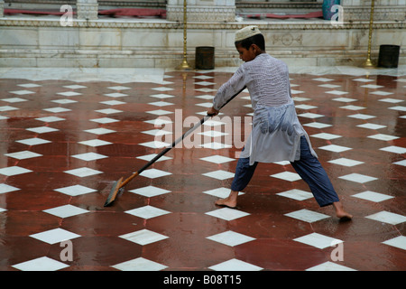 Boy cleaning a Sufi shrine, Bareilly, Uttar Pradesh, India, Asia Stock Photo