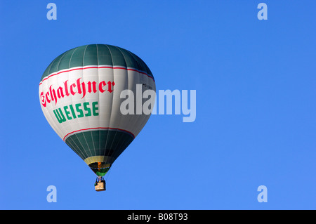 Green-and-white hot air balloon in a blue sky, Bad Wiessee, Upper Bavaria, Bavaria, Germany Stock Photo