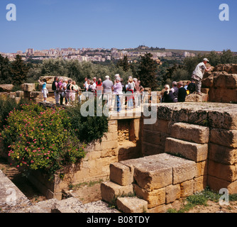 Tourists visiting the temple of Giove Jupiter or Zeus Valley of the Temples Agrigento Sicily Italy EU. Stock Photo