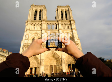 Notre Dame de Paris being photographed by a tourist, Paris, France Stock Photo
