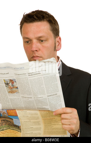 40 year-old businessman reading a newspaper Stock Photo
