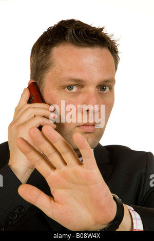 40-year-old businessman talking on the phone, defensive gesture Stock Photo