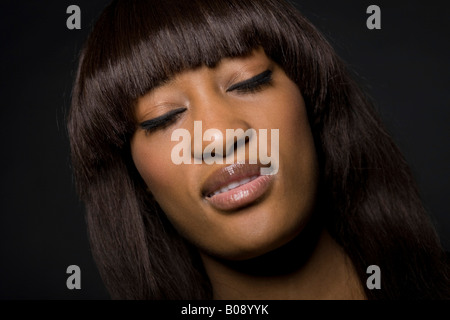 Portrait of a young dark-skinned woman with her eyes closed Stock Photo