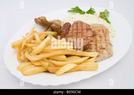 Grilled cutlets served with coleslaw and french fries Stock Photo