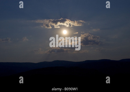 Moon between clouds over the Black Forest, Germany, Baden-Wuerttemberg Stock Photo