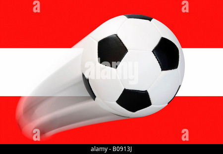 Football flying in front of an Austrian flag - series Stock Photo