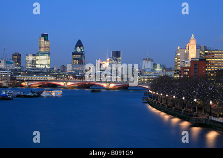 City of London skyline, skyscrapers including the Swiss Re Tower at dusk, London, England, UK Stock Photo