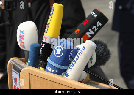 German press microphones attached to a lectern Stock Photo