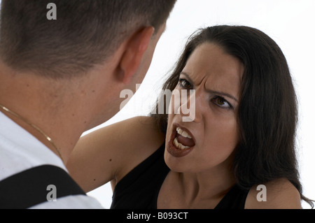 Woman shouting at a man, telling him off Stock Photo
