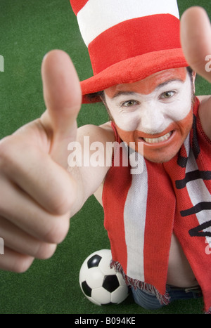 optimistic Austrian soccer fan makes thumbs up Stock Photo