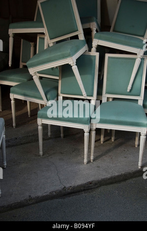 Chairs stacked haphazardly on top of one another Chairs stacked haphazardly on top of one another