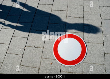 Pedestrian's shadow and traffic sign: no entry on a sidewalk, footpath in Munich, Bavaria, Germany Stock Photo