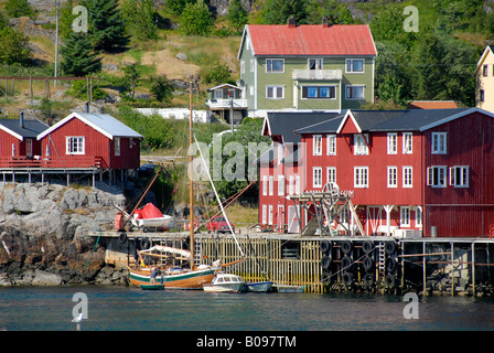 Old sailboat and red wooden 'rorbu' houses, Lofoten Archipelago, Norway, Scandinavia Stock Photo