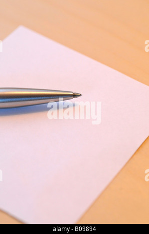 Pen laying on a blank piece of paper Stock Photo