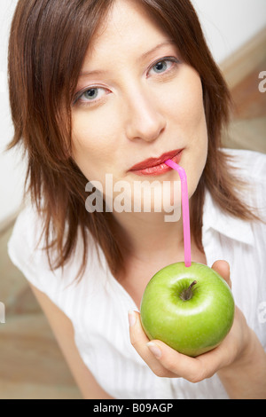 Woman drinking pure apple juice Stock Photo