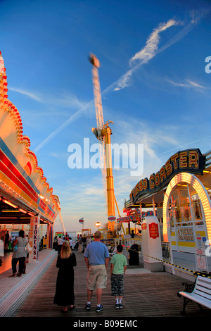 People watching the funfair rides on Brighton Palace Pier Sussex England Britain UK Stock Photo