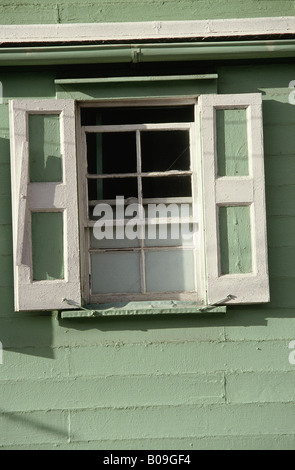 Detail of green and white shutters (open) in green painted clapboard wooden house ST JOHNÕS ANTIGUA Stock Photo