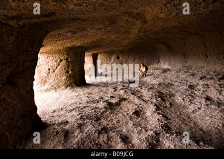 Visitor in Cuevas de Cuatro Puertas archaeological site 'Gran Canaria' Spain Stock Photo