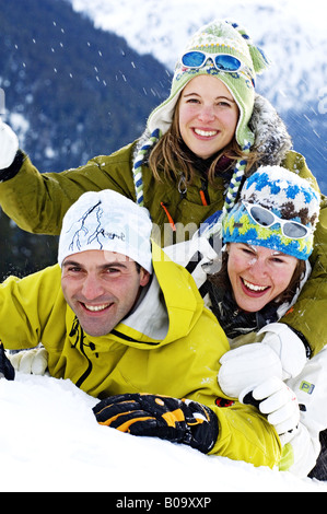 three friends on winter holiday, having fun in the snow, France, Alps Stock Photo