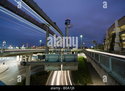 monorail, roads and flight control tower at Dusseldorf airport at night, long exposure Stock Photo