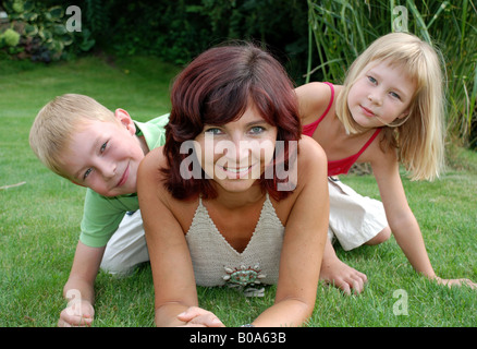 mother with two children on the meadow Stock Photo