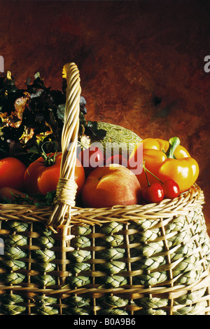 Assorted fruits and vegetables in basket, cropped view