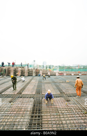 Workers building steel framework at construction site Stock Photo