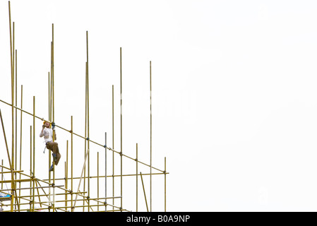 Worker on scaffolding, low angle view Stock Photo