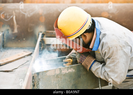 Welder working, side view Stock Photo