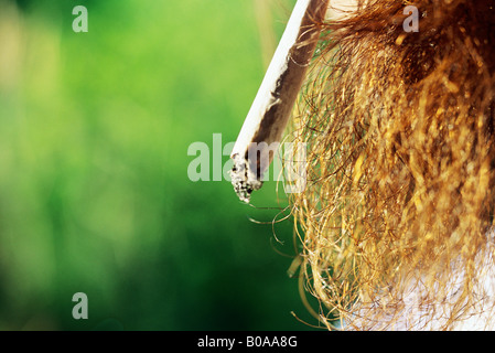 Man smoking hand-rolled cigarette, extreme close-up Stock Photo