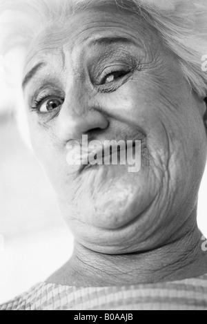 Senior woman making face at camera, portrait Stock Photo