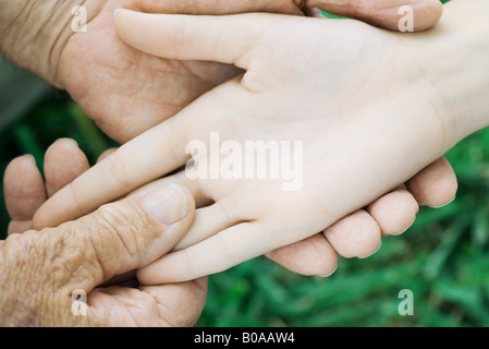 Elderly man holding female's hand, close-up, cropped view Stock Photo