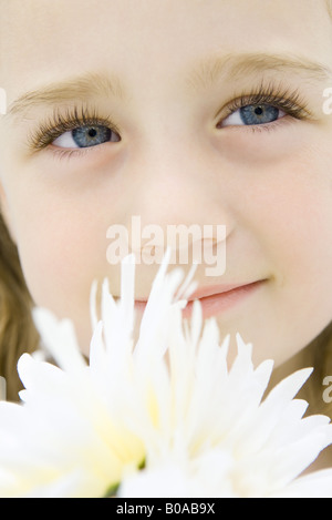 Little girl with flowers, looking up, smiling, portrait Stock Photo