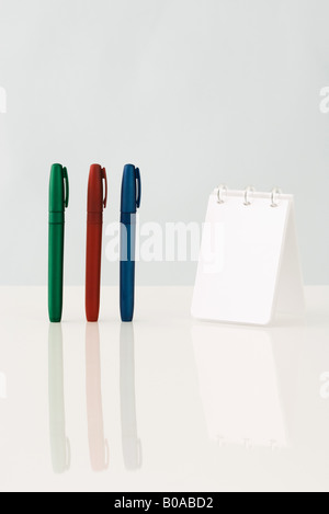 Pens and spiral notebook, close-up Stock Photo