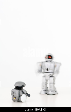 Two robots approaching each other Stock Photo