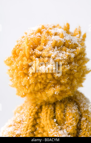 Knit hat dusted with snow, close-up of pompom Stock Photo