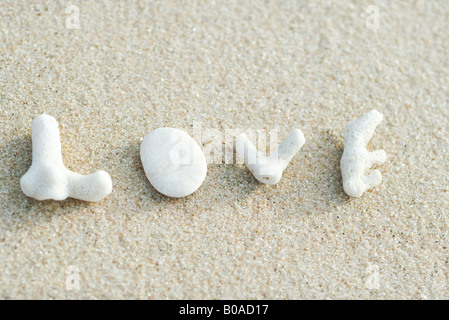 Coral pieces spelling out the word 'love' on the beach Stock Photo