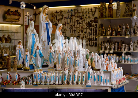 Madonnas and religious artifacts for sale for the pilgrims arriving in Lourdes, France Stock Photo