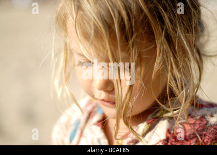 Portrait of a beautiful and tender mixed race small girl half thai looking down Stock Photo