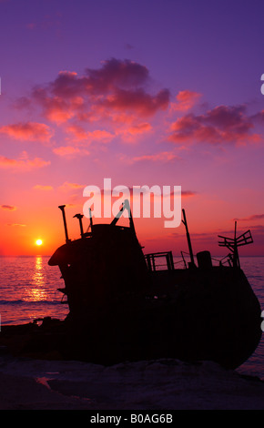 The sun sets on a shipwreck in Bimini, Bahamas Stock Photo