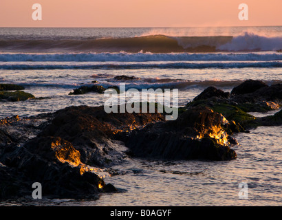 Waves crashing as the sun sets on Croyd beach North Devon UK Stock Photo